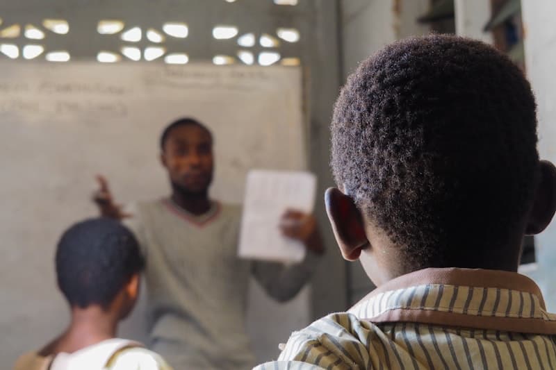 Teacher tutoring student in lab